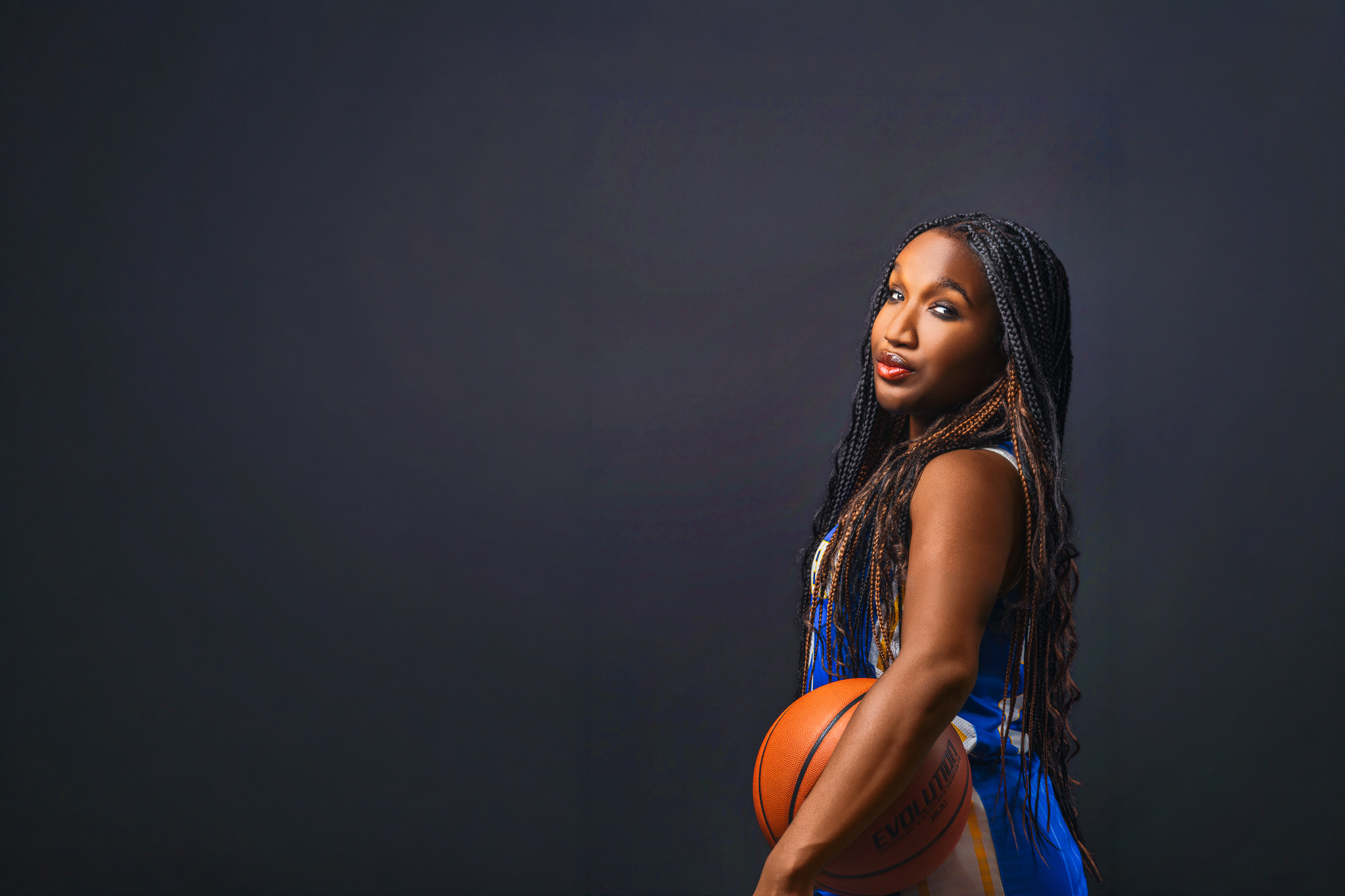 Elite athlete identity portrait — basketball player in dramatic studio lighting, demonstrating the authority and presence that commercial sports photography demands